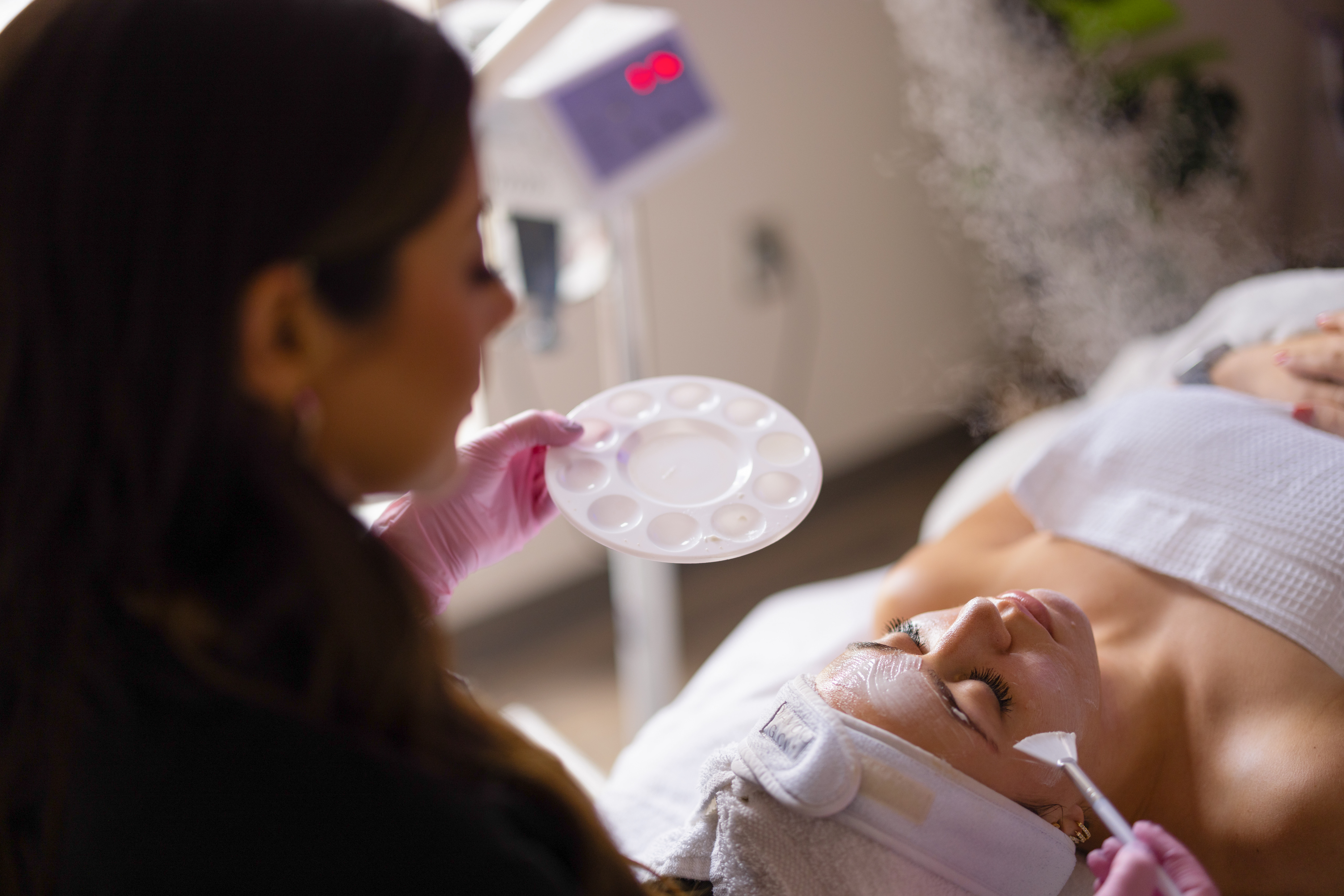 A med spa nurse performing the RBB Signature Facelift Peel on a client at Rochester Beauty Bar.