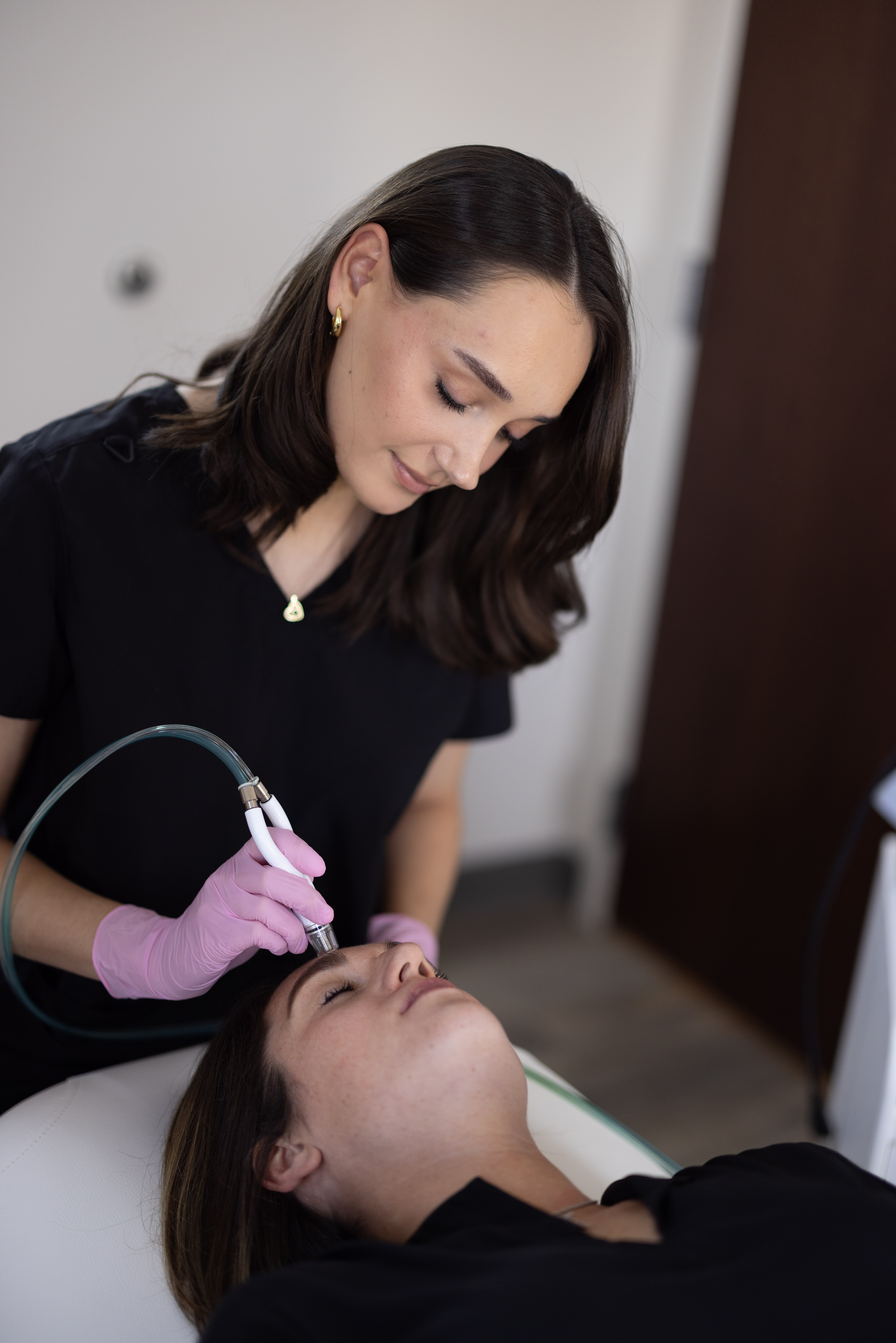 Client receiving a DiamondGlow treatment from a professional esthetician at a medical spa.